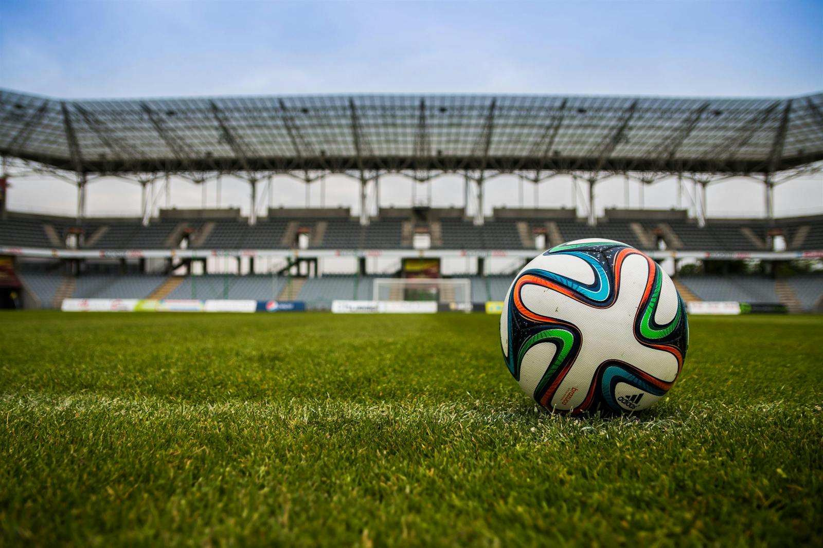 Soccer ball on green grass at a stadium ahead of World Cup 2026 watch parties